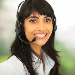 Woman with long black hair smiling and wearing a headset